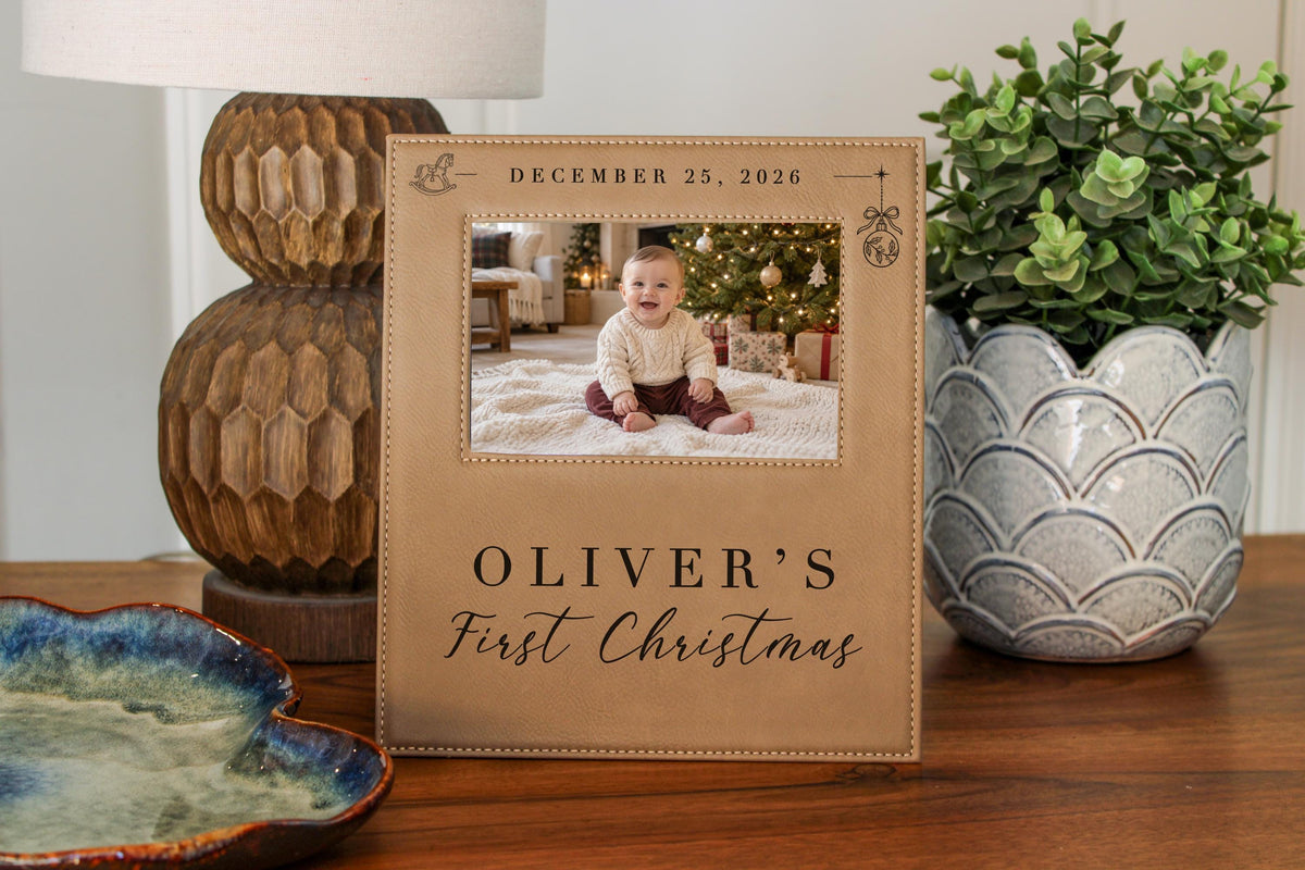 Edited mockup of Xmas Rocking Horse frame beside a lamp, decorative dish and plant, with an illustrative baby Christmas photo and the sample name Oliver’s.