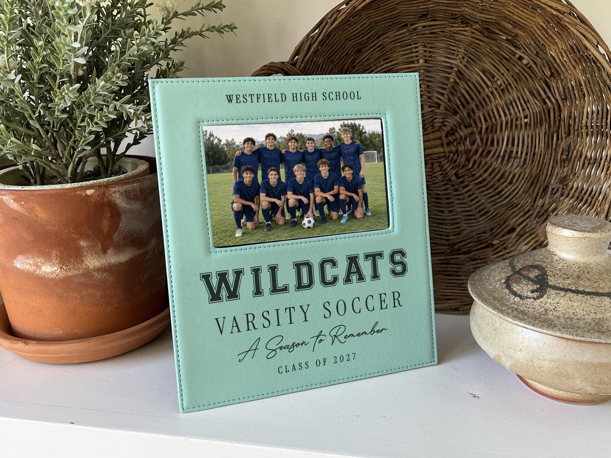 Edited Varsity Season frame mockup with an illustrative soccer team photo and sample Westfield High School, Wildcats, Varsity Soccer, A Season to Remember and Class of 2027 engraving.