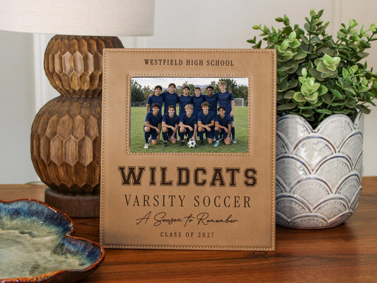 Edited Varsity Season frame mockup with an illustrative soccer team photo and sample Westfield High School, Wildcats, Varsity Soccer, A Season to Remember and Class of 2027 engraving.