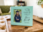 Grad Cap engraved frame reading Class of 2027, Olivia Bennett, Westbridge High School, with an illustrative graduation portrait. Edited mockup with sample personalization.