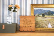 Farmhouse Harvest personalized cutting board mockup with farmhouse, apple tree and vegetables, showing Cedar Hollow, Homestead and Est. 2026.