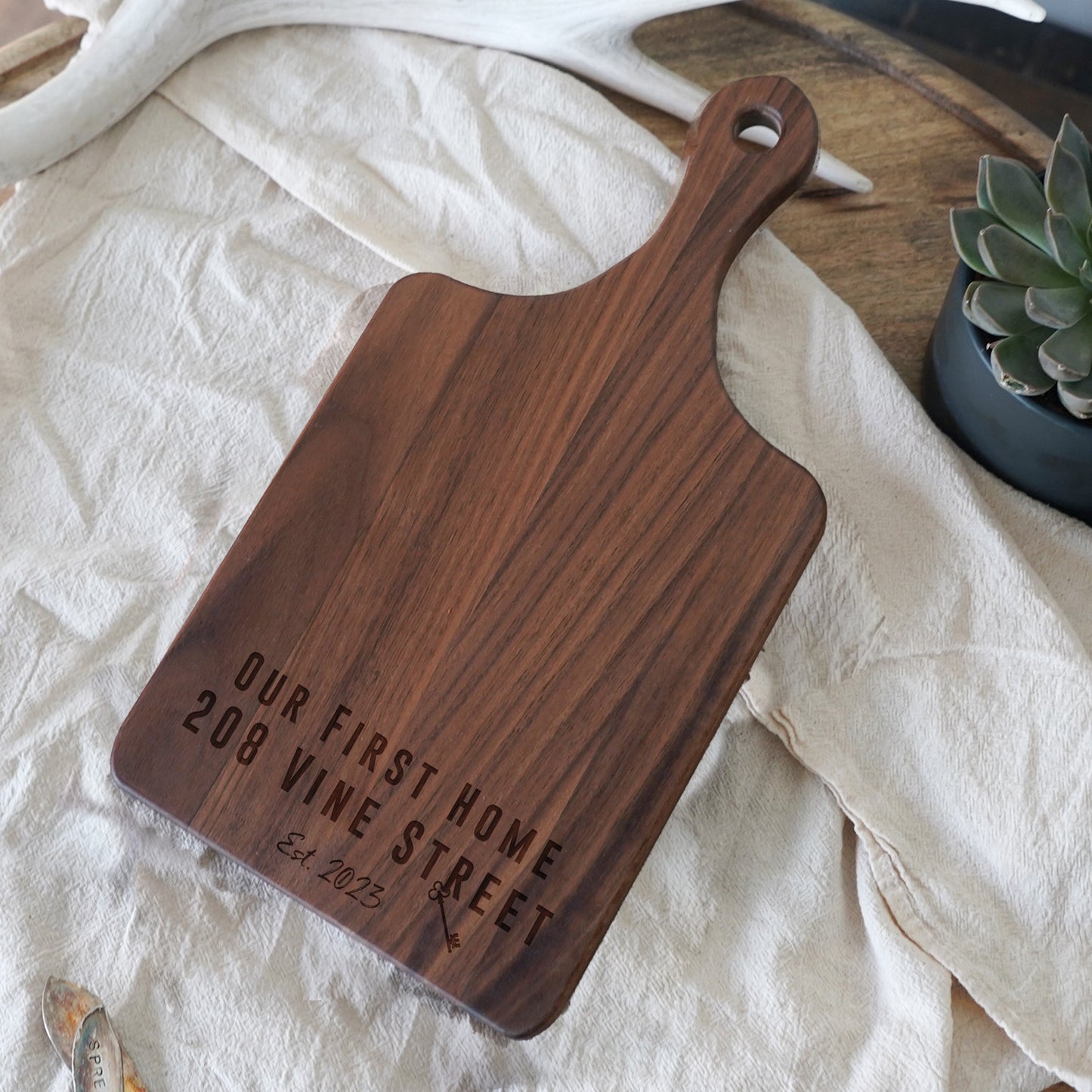 a wooden cutting board sitting on top of a table