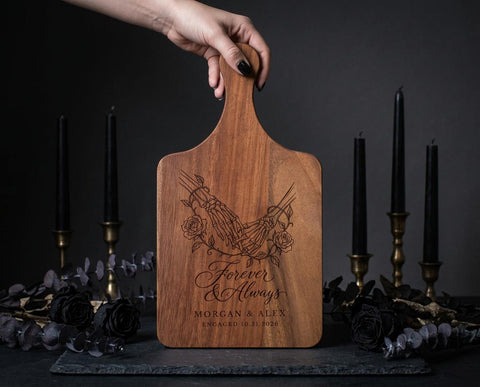 Forever Hand in Hand cutting board design with skeleton hands, roses, and sample names Morgan & Alex