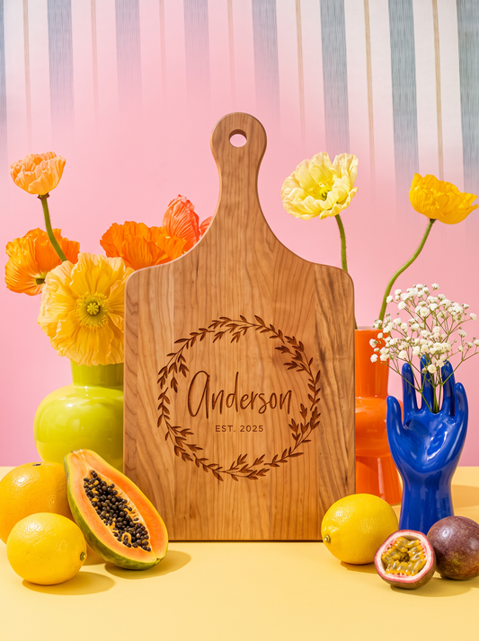 Leaf Wreath Family Name Cutting Board in a colorful floral setting