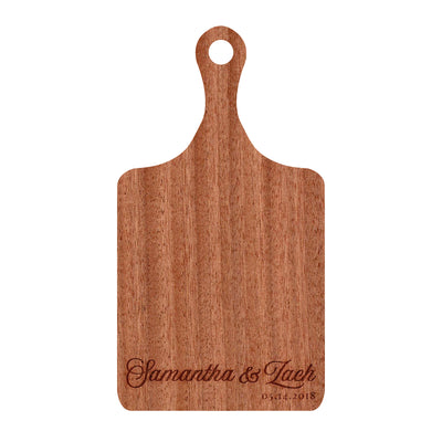 a wooden cutting board with a name on it