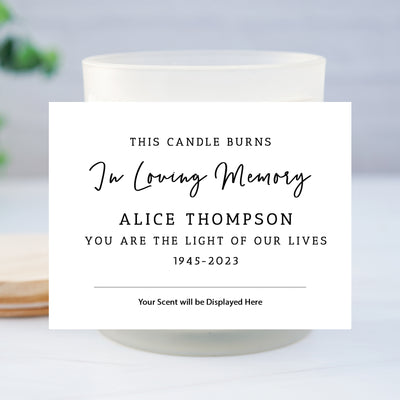 a candle burns in loving memory with a card