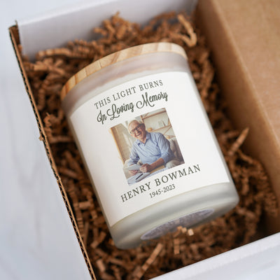 a candle in a box with a picture on it
